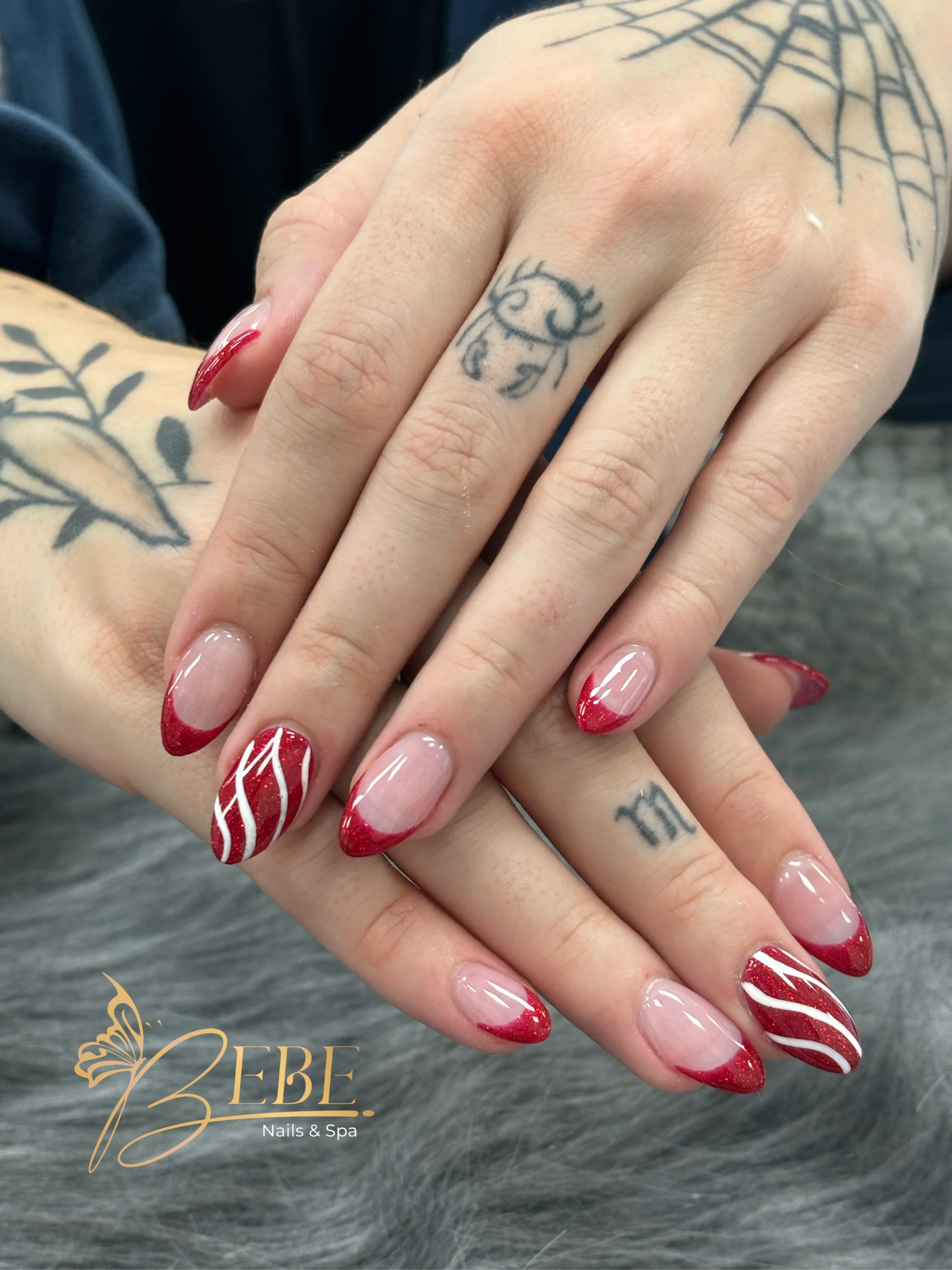 Black and red nails with hand painted swirl art