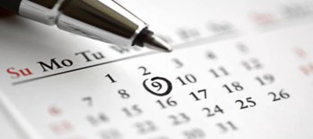 Pen and calendar with a circled appointment date