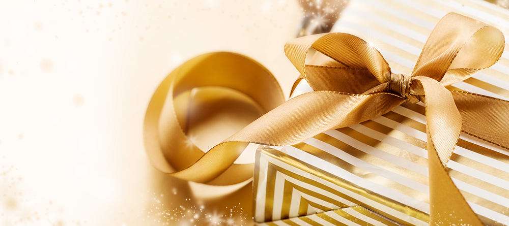 Gold gift boxes and ribbon representing salon gift cards